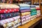 selection of handmade quilts stacked on a wooden shelf