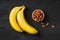 Selection of healthy food for heart. Bananas and almond on black gooden