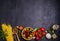 Selection of healthy food. Italian food background with spaghetti, mozzarella parmesan cheese, olives, tomatoes and rosemary.