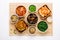 Selection of Korean Asian food in bowls on bamboo mat