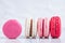 Selection of macaroons in different colors on bright white background