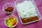 A selection of Malaysian lunch takeaway food in plastic containers. Healthy food delivery