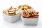 Selection of mix pretzels, sticks, crackers and salty snacks in white ceramic bowls isolated on white background