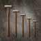 A selection of precision carpentry hammers on a stone backdrop