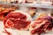 Selection of quality meat in a butcher shop. Raw pork knuckles are on display. Meat assortment