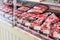 Selection of raw fresh veal meat in the refrigerated display of a butcher shop