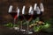 Selection of red wine on wine tasting. Dry, semi-dry, sweet red wines in special wine glasses on old wooden table background. Copy