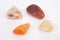 A selection of sacral chakra healing gemstones against a white background