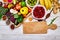 Selection of superfoods around cutting board on white background.