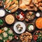 Selection of traditional greek food salad, meze, pie, fish, tzatziki, dolma on wood background, top view