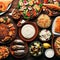 Selection of traditional greek food salad, meze, pie, fish, tzatziki, dolma on wood background, top view