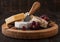 Selection of various cheese on the board and grapes on wooden background. Blue Stilton, Red Leicester and Brie Cheese and nuts