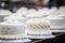 Selection of white wedding cakes at wedding fair or pastry shop