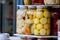 Selective blur on glass jars of home canning, pickled vegetables, on a market in romania, mainly canned cauliflower