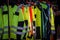 Selective blur on high visibility safety coats and jackets, personal protective equipments, for sale outside, fluorescent colors.