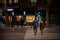 Selective blur on Old senior man and woman, couple, wearing a facemask, waking in street of Belgrade in winter at night on covid