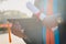 Selective and close-up focus of a university graduate holds a degree certificate and graduation cap celebrates in the graduation c