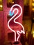 Selective closeup of a neon light flamingo in a cafe