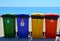 Selective collection of garbage colored containers. Yellow, green, blue and red recycle bins with recycle