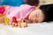 Selective focus. Adorable child fell asleep with a wooden figure train toy Number in her hand while the little girl sleepy.