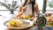 Selective focus of  Alarm clock with woman eating a healthy food as Intermittent fasting, time-restricted eating-Diet breakfast