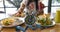 Selective focus of  Alarm clock with woman eating a healthy food as Intermittent fasting, time-restricted eating-Diet breakfast