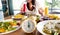 Selective focus of Alarm yellow clock  with Diet plan with woman eating healthy food