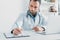 selective focus of attentive doctor writing