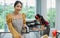 Selective focus on beautiful Asian woman using and preparing equipment to make bread in weekend in comfortable indoor kitchen at