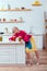 selective focus of beautiful stylish housewife with cans of pickled vegetables on counter