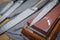 Selective focus on the blade of a steel kitchen knife lying on a water whetstone