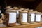 Selective focus on blank labeled seasoning jars inside a cupboard in a home kitchen