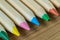 Selective focus on blue color of color pencils pile on wood table as art or education concept