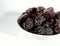 Selective focus.Blur dried sweet dates on bowl isolated on blur white background. Healthy food concept.