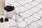 Selective focus of bottle of homemade yogurt and sugar bowl with blackberries near plaid fabric