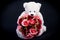 Selective focus at bouquet of red roses on white bear doll