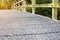 Selective focus of cement bridge with wooden rack walkway along to the forest