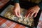 Selective focus on chef confectioners hands over a baking sheet with carved molds of gingerbread dough. Christmas baking