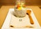 Selective focus of chia pudding glass jar on a cloth next to a wooden s