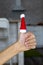 selective focus on child& x27;s right thumb showing ok sign, wearing little santa claus hat