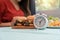 Selective focus of clock, Young woman ready to eating a hamburger, French fries, for Breakfast. Concept of binge eating disorder