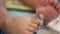 Selective focus and close up of a little baby`s toes / feet being painted
