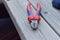 Selective focus closeup shot of a red cutting plier on a wooden table