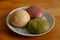 Selective focus of colorful handmade dough on plate with light and shadow, Three balls of fresh homemade wheat dough on kitchen