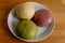Selective focus of colorful handmade dough on plate with light and shadow, Three balls of fresh homemade wheat dough on kitchen