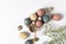 Selective focus of coloured decorated easter eggs in cardboard container, gypsophila flowers