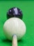 Selective focus on cue and blurred white snooker ball dirty blue