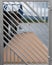 Selective focus of diagonal metal fence against a blurred dock backgrou