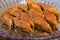 Selective focus of diamond shape homemade Turkish baklava in a glass plate. Baklava with walnut. Cevizli baklava in Turkish