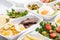 Selective focus of eco package with salad, apples, fried eggs and meat on white background.